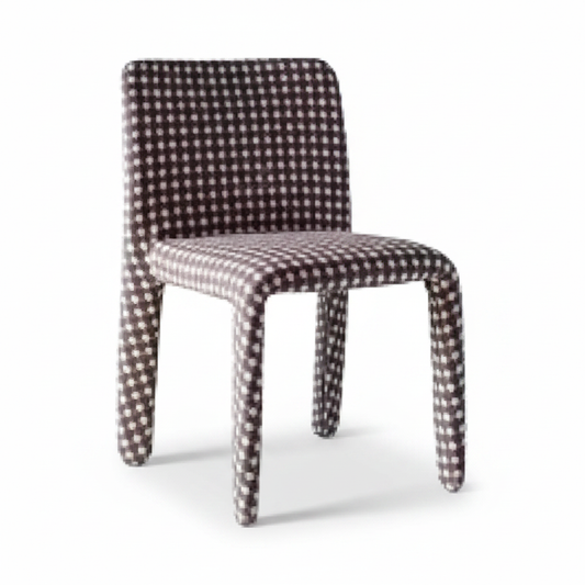 Three-quarter angled view of the Damier Dining Chair showing the rounded backrest and fabric-wrapped legs