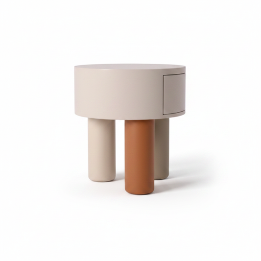 Side view of cream cylindrical bedside table showing three cylindrical legs in terracotta, cream, and grey