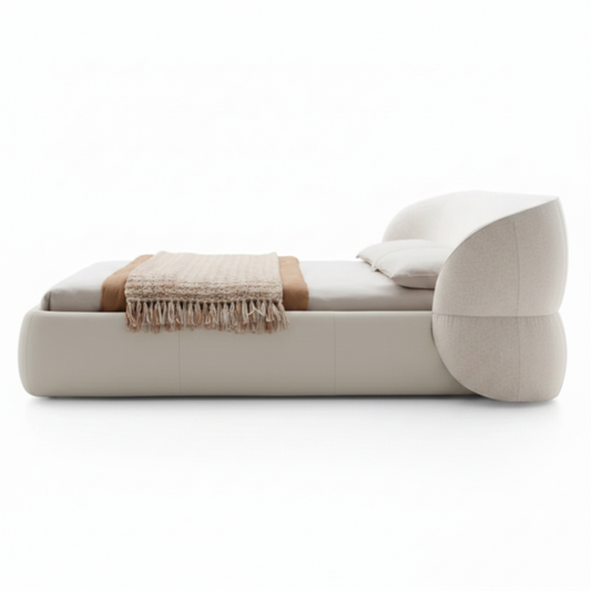 Forma sculptural asymmetric upholstered bed in cream, side view