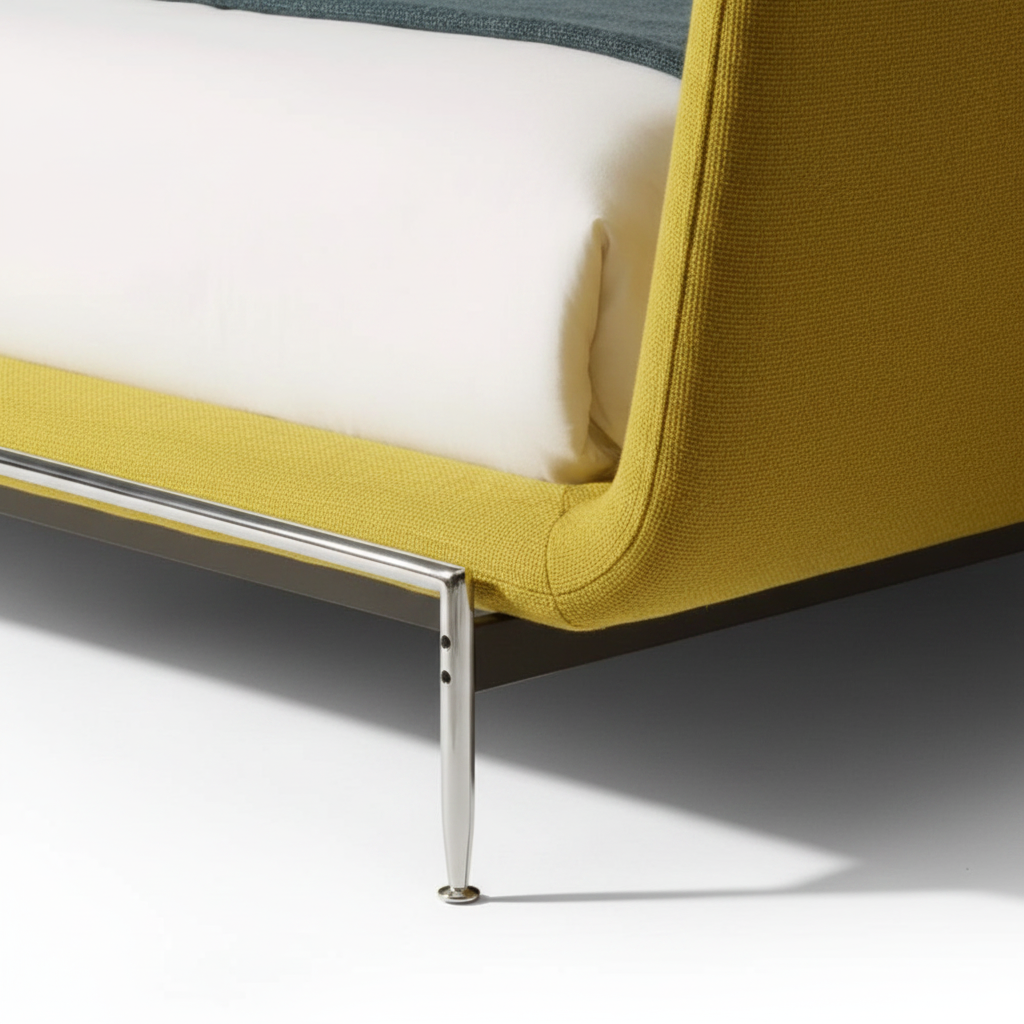 Sole king bed — close-up mustard yellow fabric and chrome leg detail
