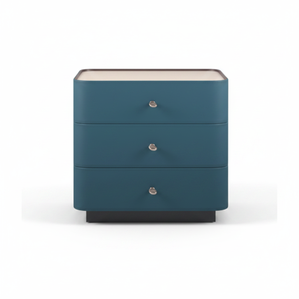 Deep teal upholstered three-drawer bedside table with cream top and silver knob handles on dark plinth base, front view on white background