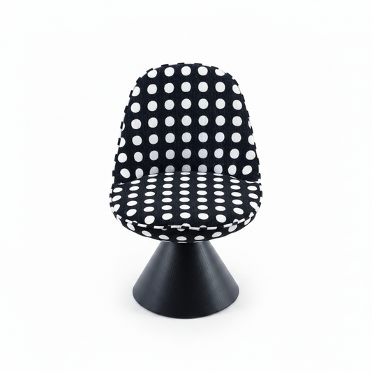 Front-facing studio shot of the Pois Accent Chair with black and white polka dot upholstery and black cone base
