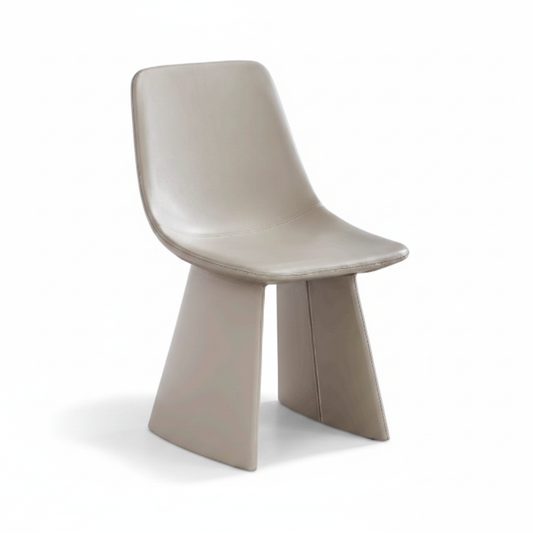 Three-quarter angled view of the Lama Leather Dining Chair showing the blade legs and shell backrest