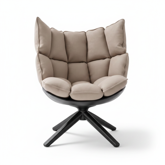 High-back grid-quilted lounge chair in warm sand fabric with matte black shell and 4-star splayed base on white background