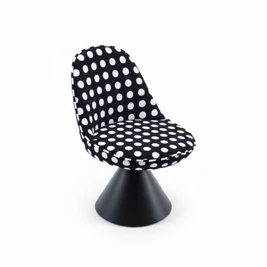 Three-quarter angled view of the Pois Accent Chair showing the polka dot shell and cone base