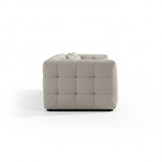 Alveo Sofa side profile, grid-tufted grey fabric, white background