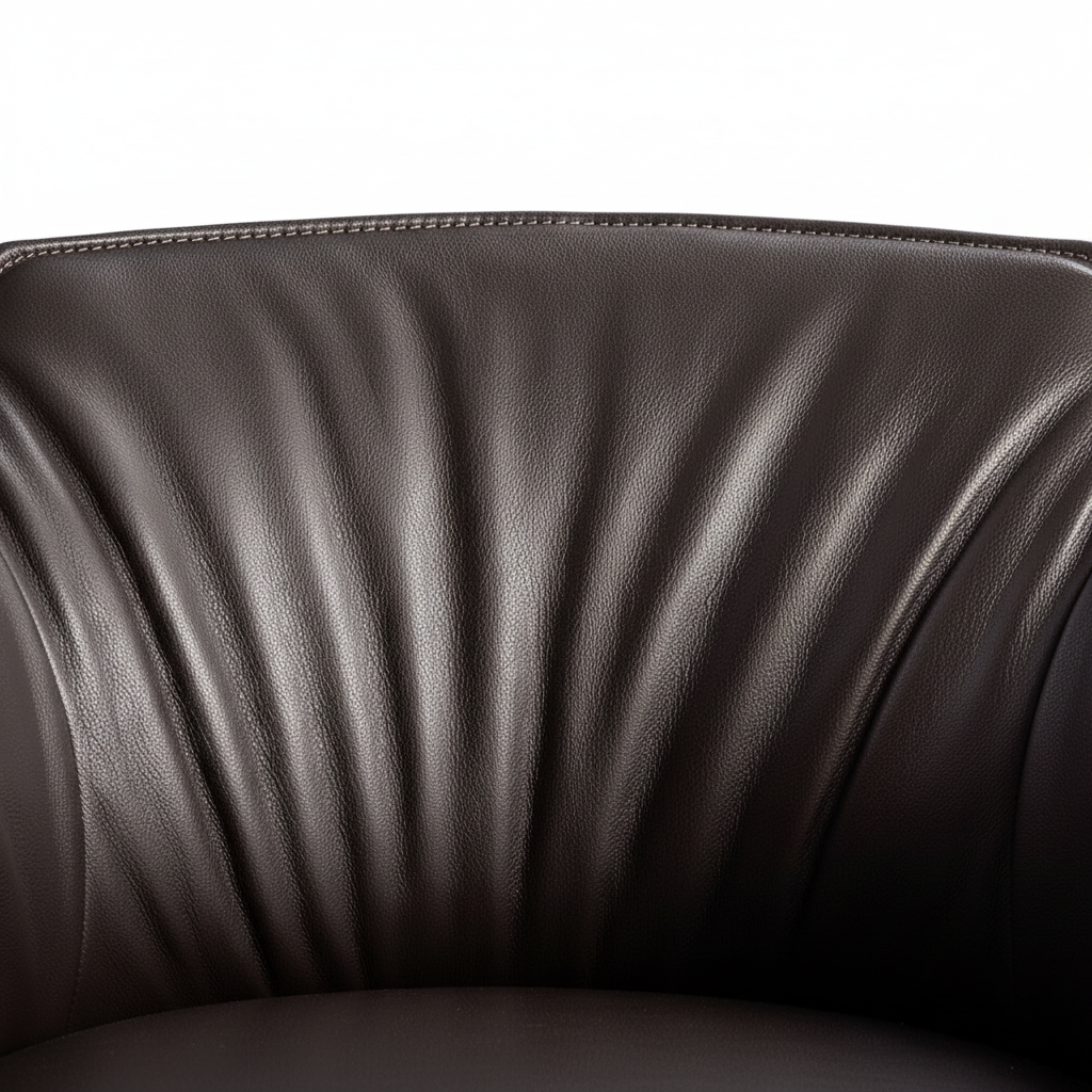 Close-up of the fan-pleated dark chocolate leather backrest and stitching detail of the Arcadia Dining Armchair