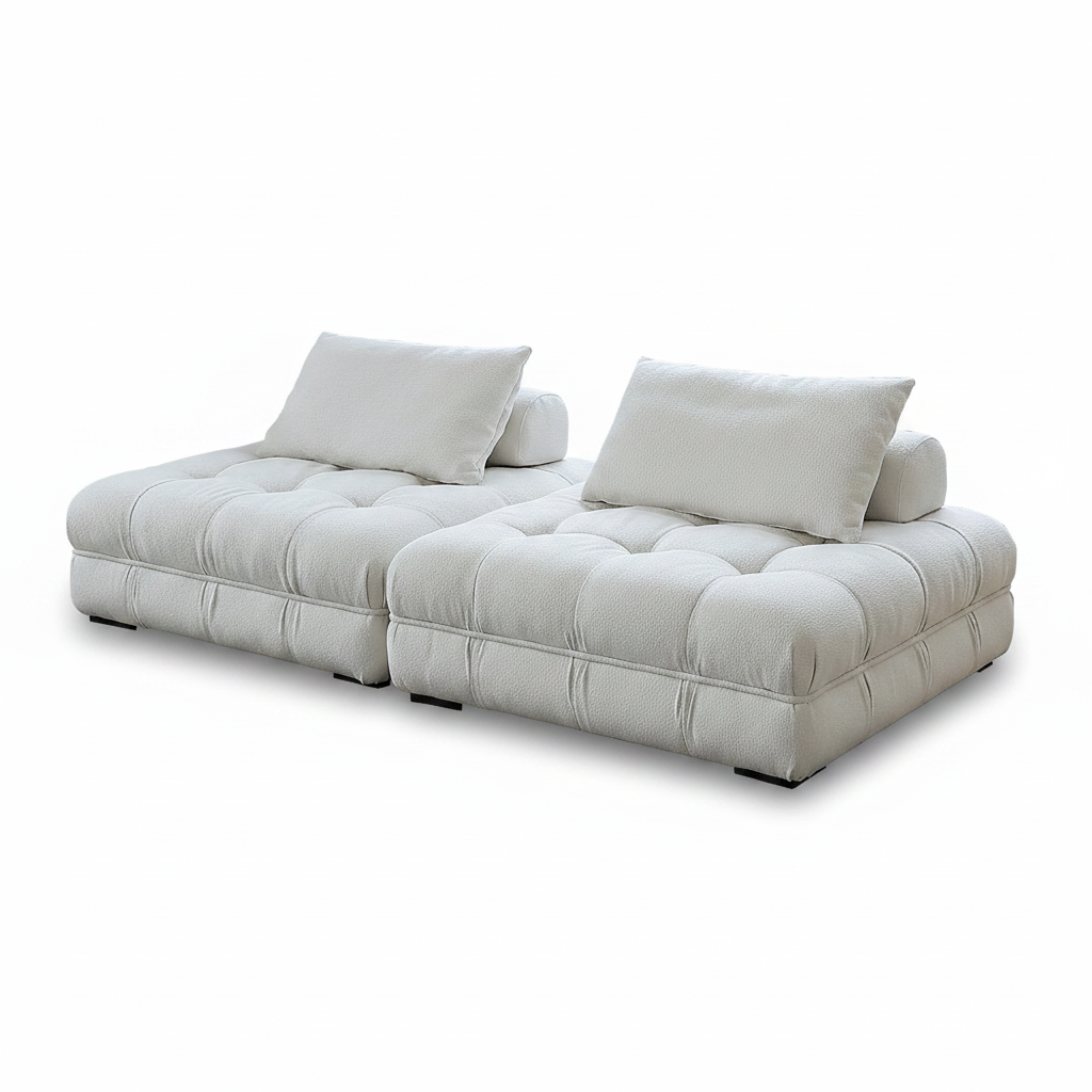 Side view of cream boucle modular sofa showing bolster backrest and tufted seat