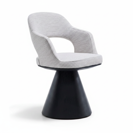 Three-quarter angled view of the Volta Dining Armchair showing the open back shell and cone pedestal base