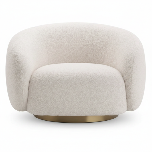 Oversized cream boucle round barrel swivel lounge chair with brushed antique brass disc base on white background