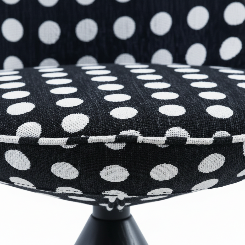 Close-up of the black and white polka dot fabric upholstery texture on the Pois Accent Chair