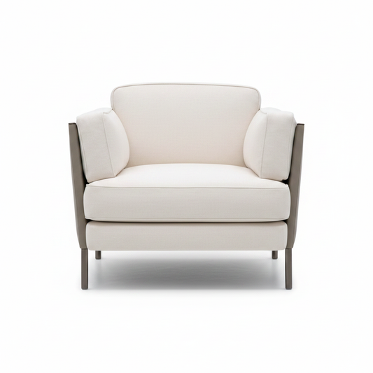 Modern lounge armchair with cream fabric cushions, taupe leather outer panels and gunmetal legs on white background