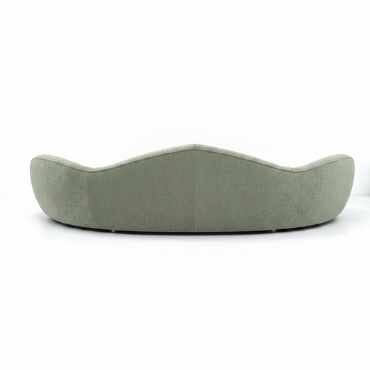Vellara curved bouclé sofa in sage green, side view