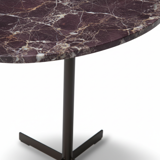 Close-up of Crux Side Table burgundy marble top and matte black cross base junction