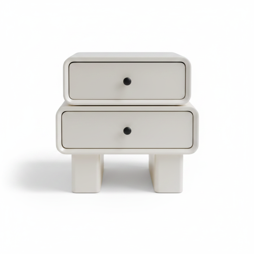 Warm cream matte two-drawer bedside table with black knob handles on chunky architectural legs, front view on white background